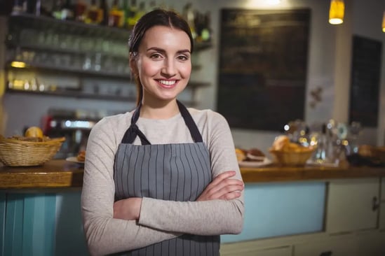 portrait-smiling-waitress-standing-counter